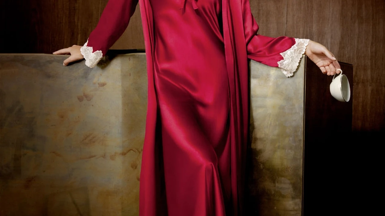 blue bowl of black bean beef tortilla soup on a board with cilantro and shredded cheese in background