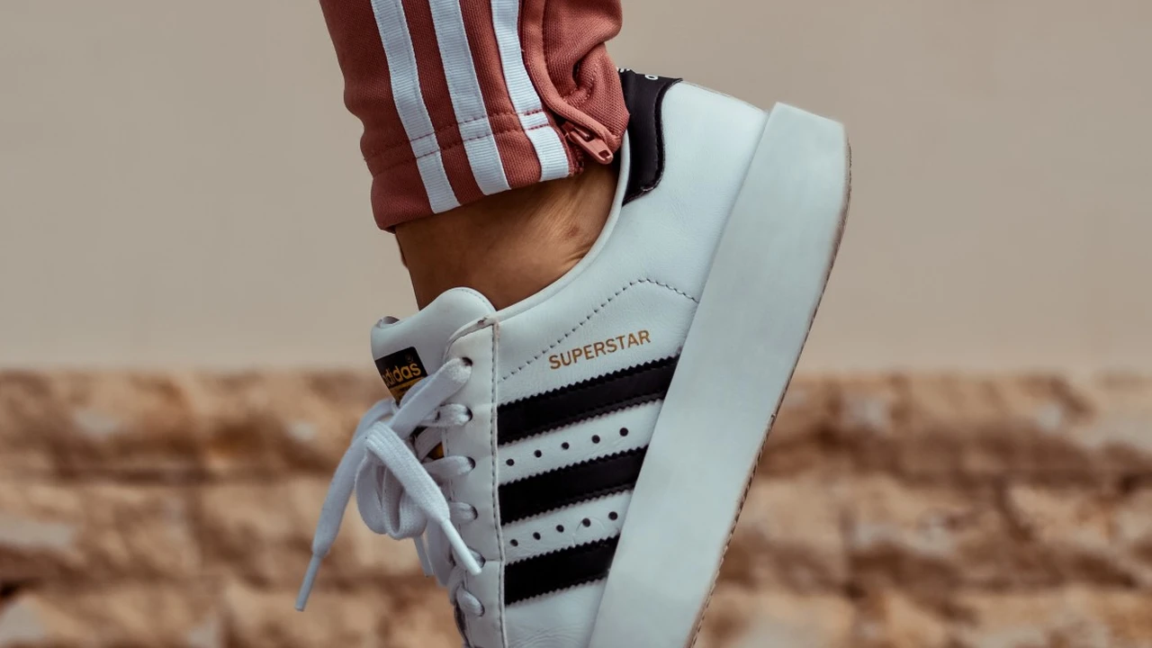 blue bowl of black bean beef tortilla soup on a board with cilantro and shredded cheese in background