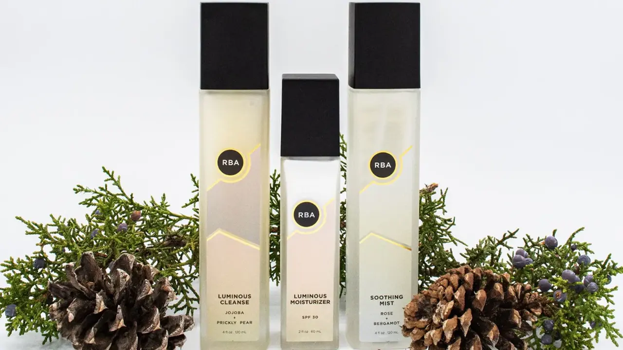 Two mint chocolate milkshakes with whipped cream and green sprinkles.